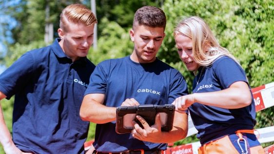 cablex employees discuss a project at the construction site.